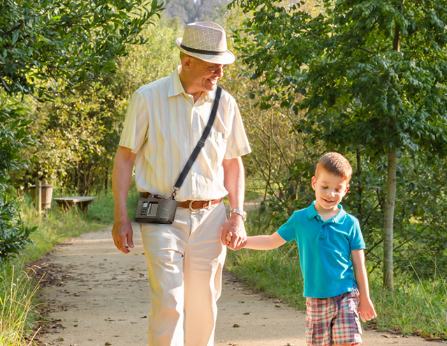Grandfather wearing LifeVest WCD walking with grandson